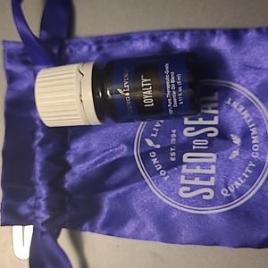 Young Living Loyalty Essential Oil with purple 💜 pouch.